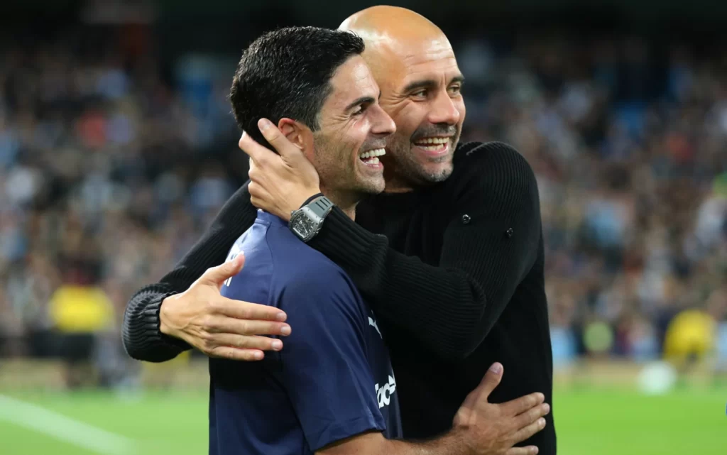 Pep Guardiola sharing a light moment with Mikel Arteta