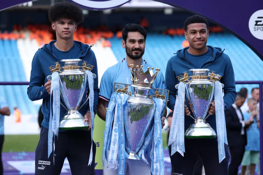 Shea Charles with the Premier League 2 trophy as the Citzens showcase their league trophies to the fans