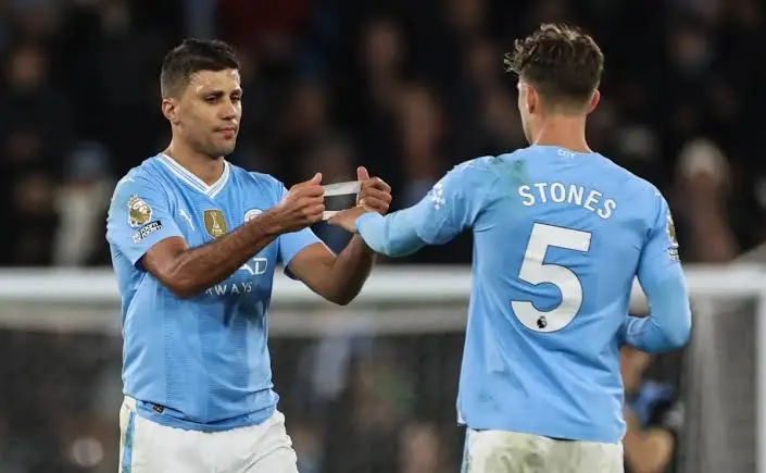 Rodri and Stones exchanging the captain armband 